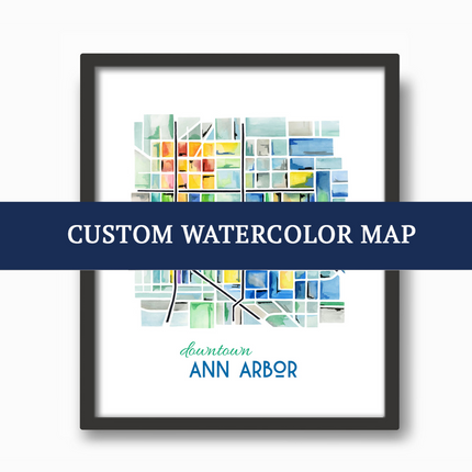 Black frame with watercolor map with text advertising custom watercolor map projects.