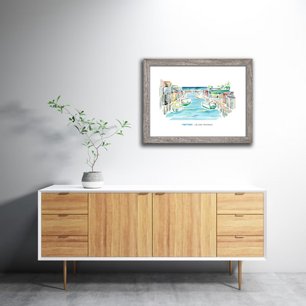 Framed watercolor of a scene in Fishtown, Leland, Michigan, featuring a dam, tugboats and fishing shanties.