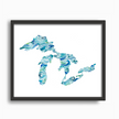 Watercolor painting of the Great Lakes, with waves in brilliant shades of blue and green, placed in a simple black frame.