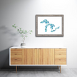Framed watercolor painting of the Great Lakes, with waves in brilliant shades of blue and green, hanging in a living room.