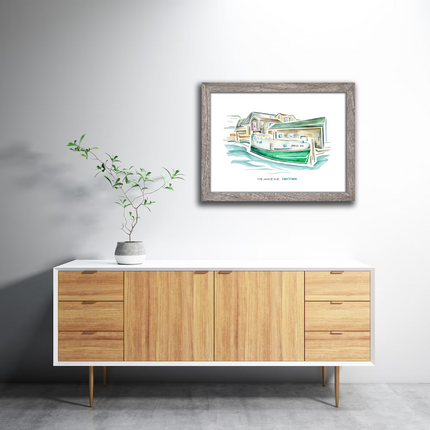 Framed watercolor of a green tugboat named Janice Sue, on the water with fishing shanties in Fishtown, Leland, Michigan.