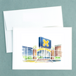 Folded notecard with a watercolor painting of Michigan Stadium, created by Emily Frushour.