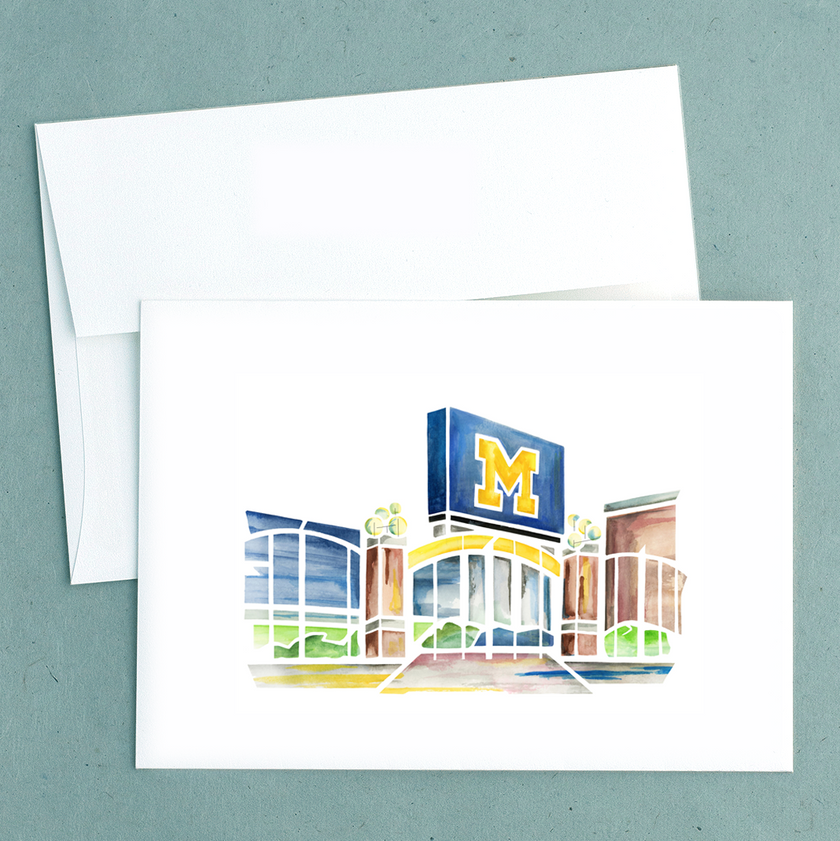Folded notecard with a watercolor painting of Michigan Stadium, created by Emily Frushour.
