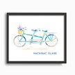 Colorful watercolor print of a green and blue tandem bike with the words Mackinac Island, in a black frame.