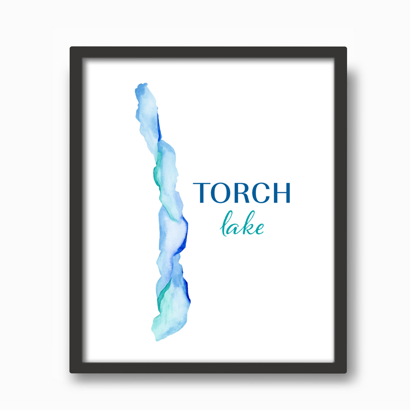 Vibrant blue watercolor print of Torch Lake in Michigan, in a black frame.