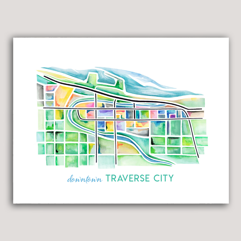 Bright and colorful watercolor painting showing a map of Traverse City, Michigan, in vibrant greens and blues.