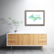 Watercolor painting of a map of Michigan's upper peninsula, created in shades of green and blue, placed in a gray frame.