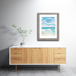 Framed watercolor of a blue and tan waterscape from the shores of Lake Michigan.