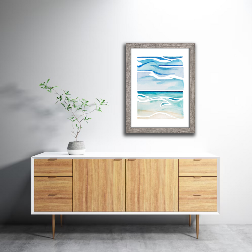 Framed watercolor of a blue and tan waterscape from the shores of Lake Michigan.