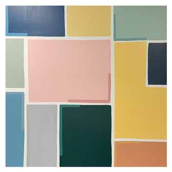 Close-up detail of a colorful and bold geometric wall mural in a school classroom.