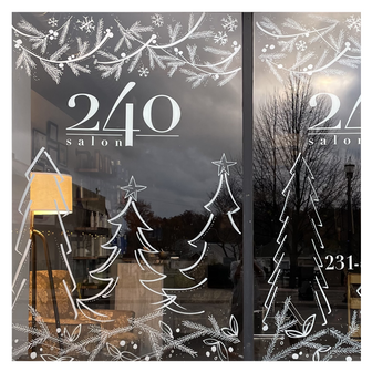 Delicate winter window art illustration showing pine branches, trees and snowflakes, created by artist Emily Frushour.